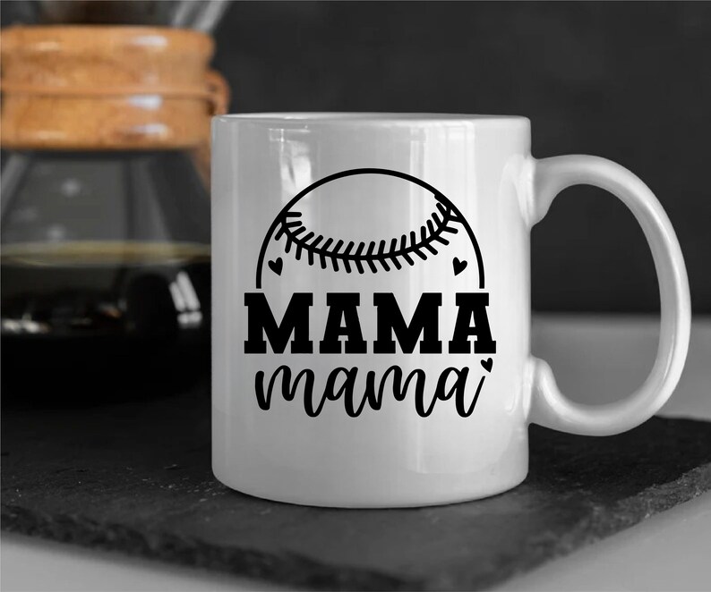 May include: White ceramic mug with a black baseball graphic and the text "MAMA mama" in black.