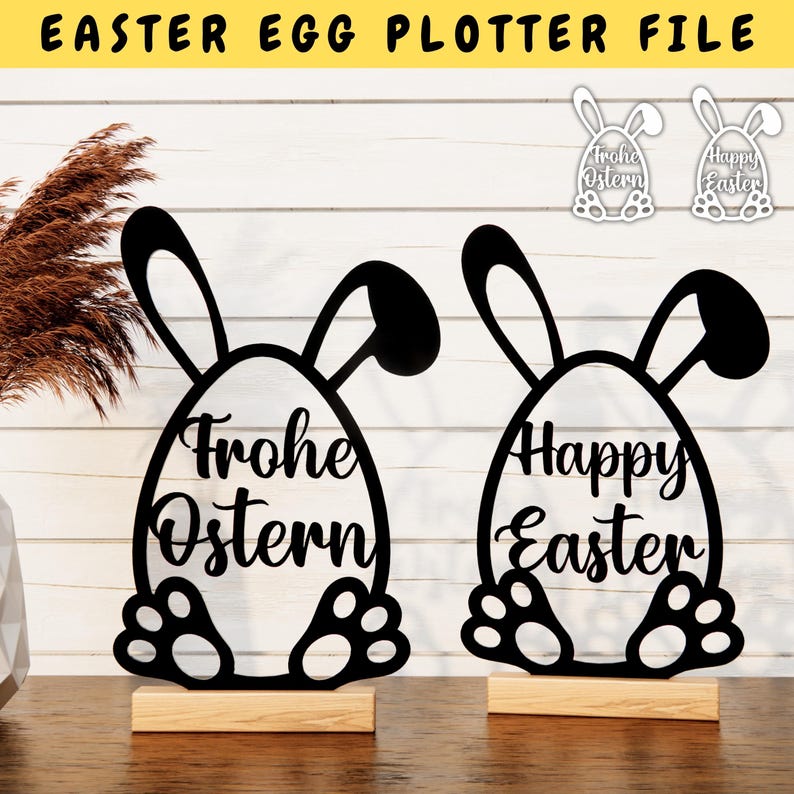 May include: Two black silhouette Easter bunny egg decorations with the text "Happy Easter" and "Frohe Ostern" on a wooden surface.