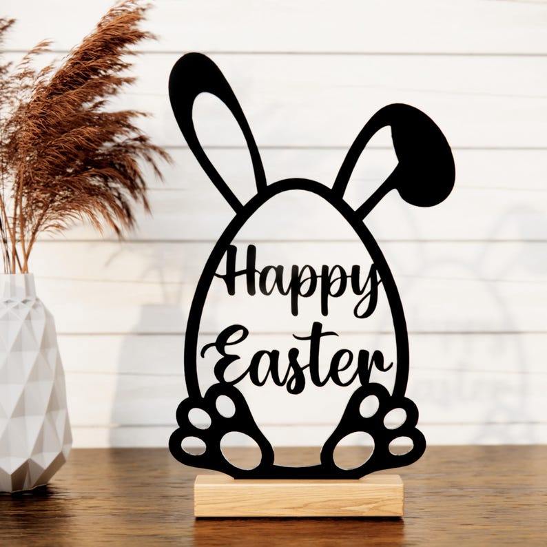 May include: Black wooden cutout of a bunny rabbit holding an egg that says "Happy Easter".