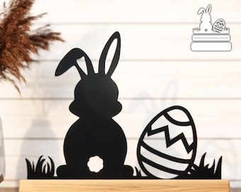 May include: A black Easter bunny silhouette and decorated egg cut file on a wooden base. The text "EASTER BUNNY & EGG WITH STAND CUT FILE" is at the top. The base has thickness options from 3 mm to 7 mm.