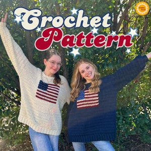 May include: Two people wearing crocheted sweaters with American flag designs. The sweaters are white and navy blue. The people are smiling and standing in front of a green bush.