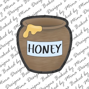 Può includere: Un tagliabiscotti a forma di vasetto di miele marrone con contorno nero. Il vasetto presenta un'etichetta rettangolare azzurra con la parola HONEY stampata in lettere maiuscole nere. Una goccia di miele gialla è visibile sul bordo superiore.