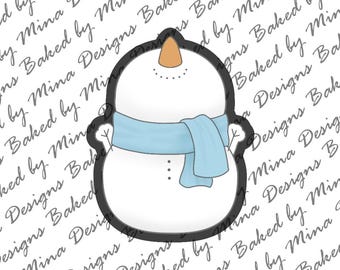 May include: A white snowman cookie cutter with a light blue scarf. The cookie cutter is outlined in black.