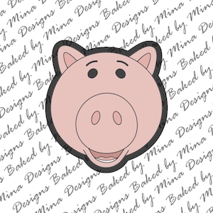 May include: A pink pig face cookie cutter with a black outline. The pig has two small black eyes, a round snout with two oval nostrils, and a smiling mouth. The cutter is designed for baking and crafting.