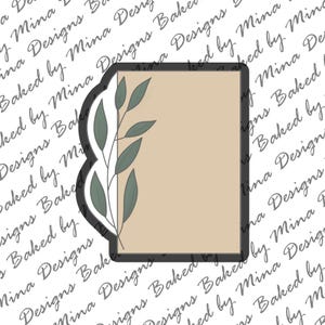 May include: A light brown rectangular card with a scalloped edge on the left side. A leafy branch with green leaves is on the left side of the card.