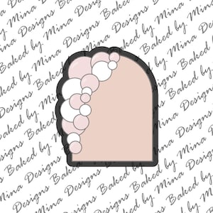 May include: A pink and white balloon arch cookie cutter. The arch is made of a series of overlapping circles, creating a cascading effect. The cookie cutter is designed for use with fondant or cookie dough.
