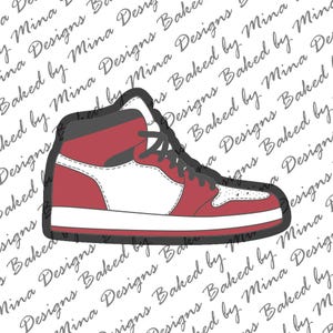 May include: A red, white, and black high-top sneaker cookie cutter. The shoe design features a red upper, white accents, and black laces and trim. The background has a repeating pattern of text that says "Baked by Mina Designs."
