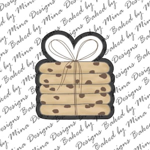 May include: A stack of six chocolate chip cookies tied together with twine and a heart-shaped bow. The cookies are brown with chocolate chips and are arranged in a stack.