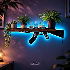 May include: A wall-mounted wooden shelf featuring a black metal silhouette of a rifle underneath, illuminated by a bright blue LED light. The shelf holds four glass perfume bottles and two potted green plants, with trailing vines.