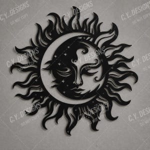 May include: A black wall art piece featuring a stylized sun and crescent moon design. The central face has closed eyes and is surrounded by radiating flame-like rays and small star cutouts. The design is flat and symmetrical in its composition.