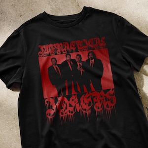 May include: Black t-shirt with a red graphic print of four men in suits standing together. The text "RESERVOIR DOGS" is above the men and "1992" is below them.