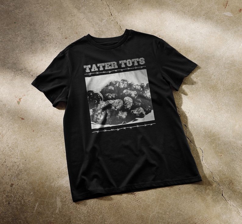 May include: Black t-shirt with a graphic print of tater tots and the text "Tater Tots" in white.