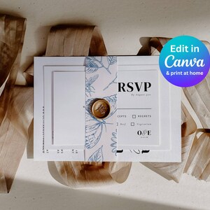 photo of the entire bundle of wedding stationery wrapped in a blue toile belly band with a gold wax seal
