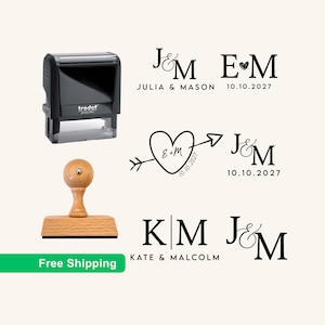 May include: A black self-inking Trodat stamp and a light brown wooden handle stamp. The image displays various black ink impressions featuring initials like J&M, E&M, and K&M, names such as Julia & Mason and Kate & Malcolm, and dates like 10.10.2027.