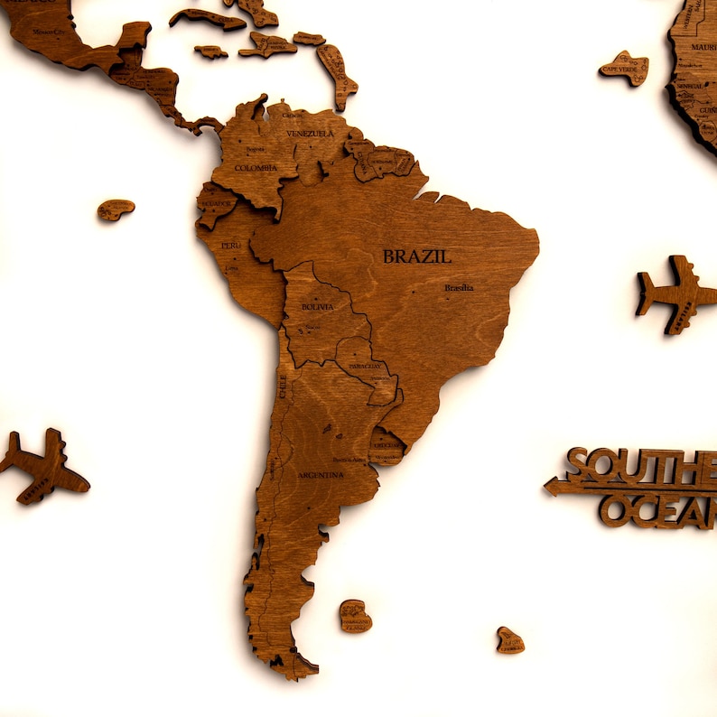 May include: A wooden world map puzzle with South America assembled. The puzzle is made of light brown wood and features the names of countries and cities. The text "SOUTHERN OCEAN" is visible in the lower right corner of the image.