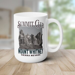 May include: White ceramic mug with a black and white image of a mountain range and the text "Summit Club Mount Whitney Sierra Nevada".