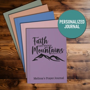 May include: A stack of personalized prayer journals with a purple cover featuring the text "Faith can move Mountains" and the scripture reference "Matthew 17:20". The journal is titled "Melissa's Prayer Journal".