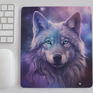 May include: A white wolf with blue eyes stares directly at the viewer. The wolf's fur is soft and fluffy, and the background is a swirling galaxy of purple, pink, and blue.