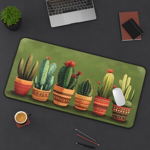 May include: A green mousepad with a row of seven potted cacti in various shades of green, red, and orange. The cacti are in colorful pots with geometric patterns.