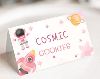 May include: Pink and white printable favor tag with a pink rocket, astronaut, and stars. The text reads "Cosmic Cookies".