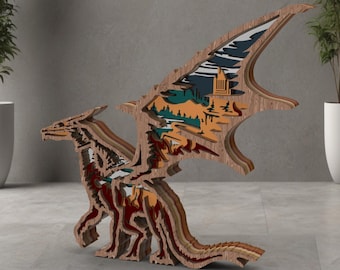 May include: A wooden dragon sculpture with layered design. The wings feature a landscape scene with a mountain, trees, and a building. The dragon is primarily brown with red, orange, and green accents, creating a 3D effect.