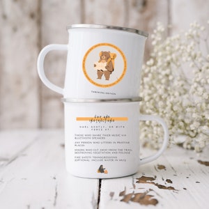 May include: White enamel camping mug with a brown bear illustration and the text "Throwing Edition". The mug has a second white enamel mug stacked on top with the text "Use and Instructions" and instructions for using the mug.