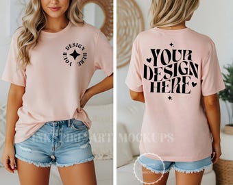 May include: A light pink short-sleeve t-shirt with black text. The front features a small circular logo with a star and the text YOUR DESIGN HERE. The back displays the large text YOUR DESIGN HERE in a wavy font with small star and heart icons.