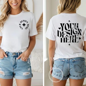 May include: A white short-sleeve t-shirt featuring a small circular black graphic on the left chest that reads YOUR DESIGN HERE with a star icon. The back of the shirt displays the same text in a large, bold, wavy font with heart and star accents.