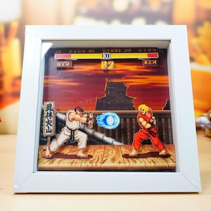 Moldura de diorama de jogos retrô 3D cortada à mão: Ryu Stage - Street Fighter 2 - Shadowbox 20 x 20 cm