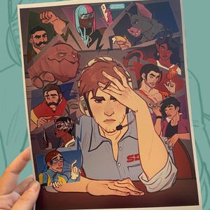 May include: A print featuring a distressed man wearing a headset, surrounded by various illustrated characters. The artwork has a comic book style with a variety of colors and expressions. The print is held by a hand.