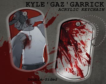 May include: Double-sided acrylic keychain with a bloody design. One side features a portrait of a man with a bloody bandage on his arm. The other side features a dog tag with the text "GARRICK KYLE 'GAZ' B-141".