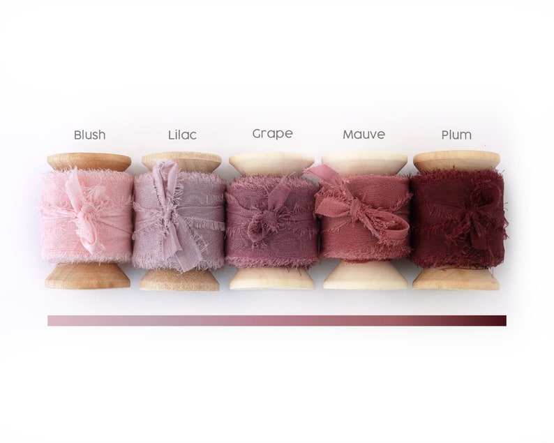Peut inclure: Cinq bobines de ruban d&eacute;coratif dans des tons de rose et de violet. Chaque bobine est &eacute;tiquet&eacute;e avec un nom de couleur : Blush, Lilac, Grape, Mauve et Plum. Le ruban a un bord effiloch&eacute; et est nou&eacute; en un n&oelig;ud.