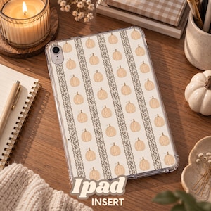 May include: A clear tablet case featuring a repeating pattern of light orange pumpkins and vertical dark brown lace-like floral borders on a cream background. The case has a circular cutout for the camera lens on the upper left corner.