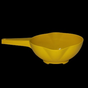 May include: A yellow plastic colander with a handle. The colander has a fluted design and a wide, shallow bowl.