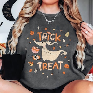 May include: A gray sweatshirt with a graphic print of a ghost holding a bucket of candy and the text "Trick or Treat".