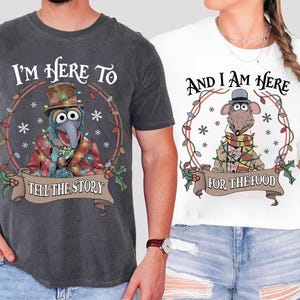 May include: Two t-shirts, one dark gray and one white, featuring Muppet characters. The dark gray shirt has Gonzo with text "I'm Here To Tell The Story." The white shirt has Rizzo with text "And I Am Here For The Food."