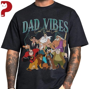 Peut inclure: T-shirt gris fonc&eacute; avec l'inscription "DAD VIBES Cool Dads Club" en lettres turquoise. Le t-shirt pr&eacute;sente des illustrations de personnages de dessins anim&eacute;s, dont un poisson, un lion et un super-h&eacute;ros.