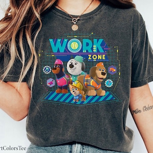 May include: A gray t-shirt with a graphic of four cartoon dogs wearing construction gear. The text "WORK ZONE" is above the dogs.