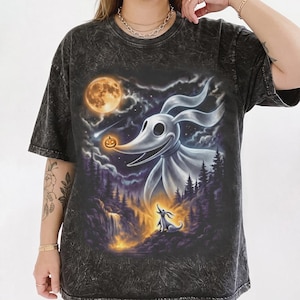 May include: A black acid-wash t-shirt featuring a graphic print of a large white ghost dog with long ears, a smaller ghost dog, a glowing orange pumpkin, a full moon, a shooting star, and a dark forest landscape with a waterfall in the background.
