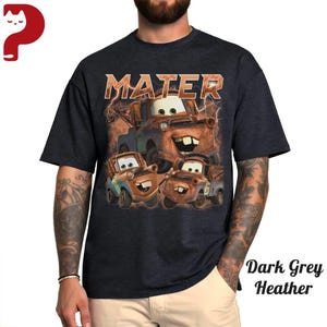 May include: Dark grey heather t-shirt featuring a graphic of the character Mater from the animated movie Cars. The word "MATER" is printed above the image in a distressed font. The image shows Mater and two other similar characters.
