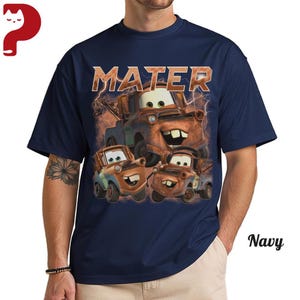 May include: Navy blue t-shirt featuring a graphic of the character Mater from the movie Cars, with the word "MATER" above the image. The design includes three images of Mater and lightning bolts.