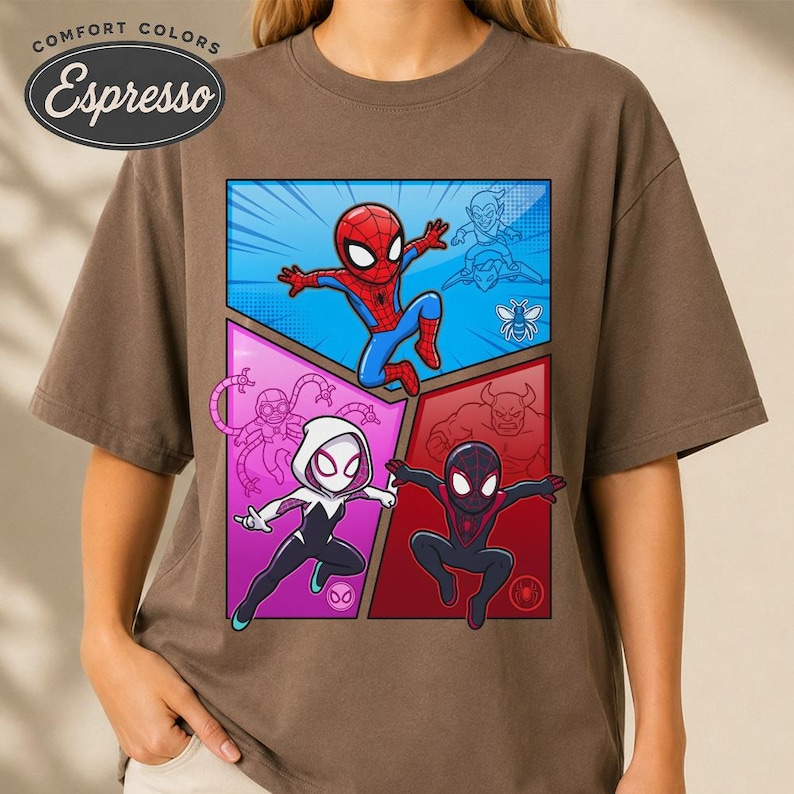 May include: Espresso-colored t-shirt featuring a colorful comic-style graphic of Spider-Man and other characters. The graphic is divided into four sections with a blue, pink, and red background. The shirt has short sleeves and a crew neck.