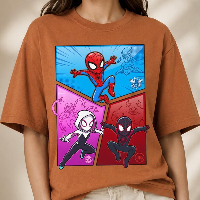 May include: A rust-colored t-shirt featuring a comic book-style graphic of Spider-Man and other characters. The graphic is divided into four sections with a blue, pink, and red background.