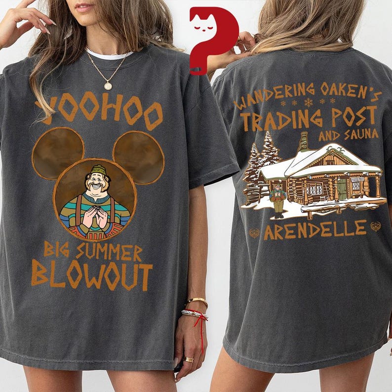May include: Dark gray t-shirt with a front graphic featuring a cartoon character in a Mickey Mouse-shaped design, the text "Yoohoo Big Summer Blowout". The back of the shirt displays "Wandering Oaken's Trading Post and Sauna" with a cabin illustration.