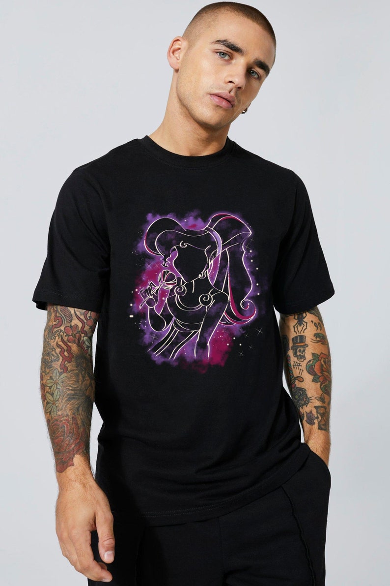May include: Black t-shirt with a purple and pink silhouette of a woman with long hair, holding a flower. The silhouette is surrounded by a purple and pink nebula-like design.