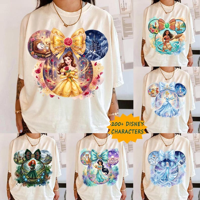 May include: Cream-coloured t-shirts with Disney character designs. Each shirt features a different princess, including Belle, Moana, Cinderella, Merida, Jasmine, and Elsa, within a Mickey Mouse ear-shaped design. The text "200+ DISNEY CHARACTERS" is visible.
