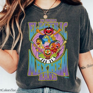 May include: A black t-shirt with a vintage-style graphic of the Electric Mayhem Band from The Muppets. The graphic features the band members playing instruments and the text "Dr. Teeth's Electric Mayhem Band".