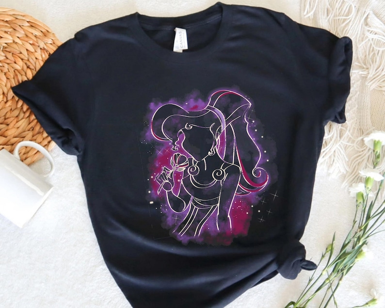 May include: Black t-shirt with a purple and pink silhouette of a woman with long hair, holding a flower. The silhouette is surrounded by a galaxy-like background.