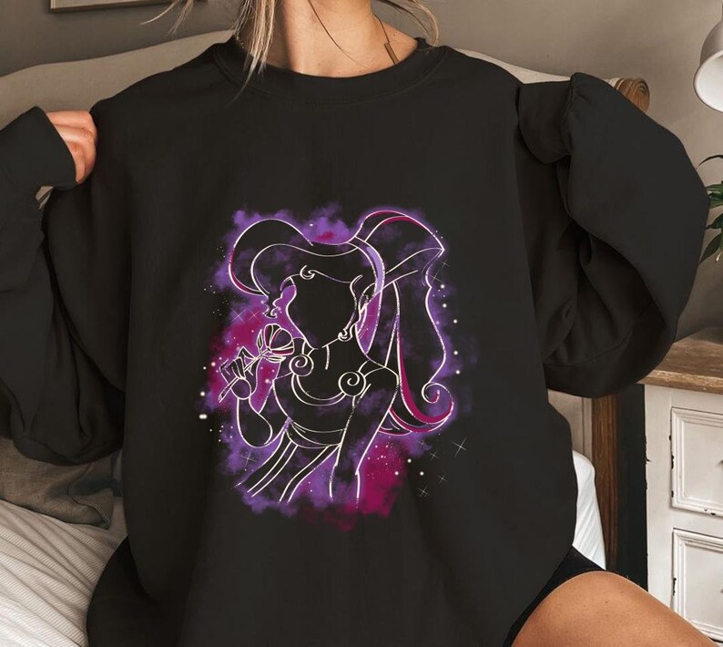 May include: Black sweatshirt with a purple and pink silhouette of a woman with long hair, holding a flower. The woman is surrounded by a purple and pink nebula.