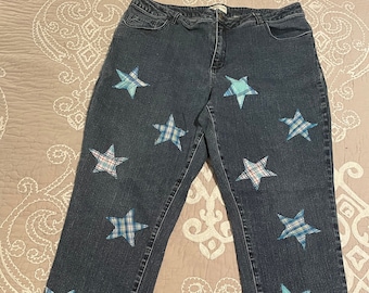 May include: Blue denim jeans with a patchwork design featuring blue and white plaid stars.